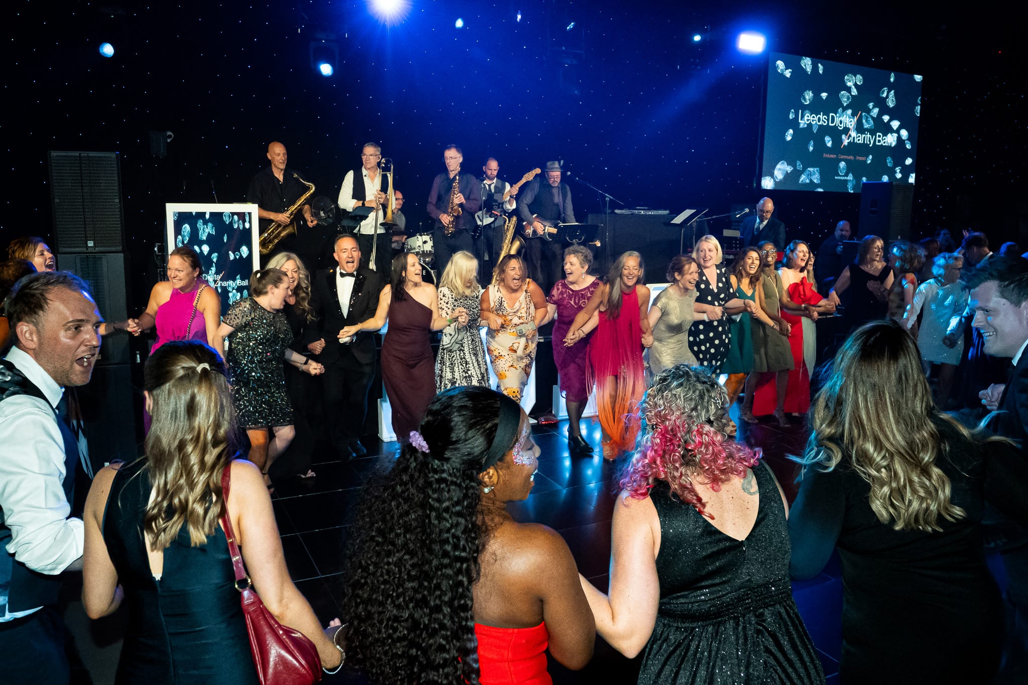 Guests dancing together in a packed circle